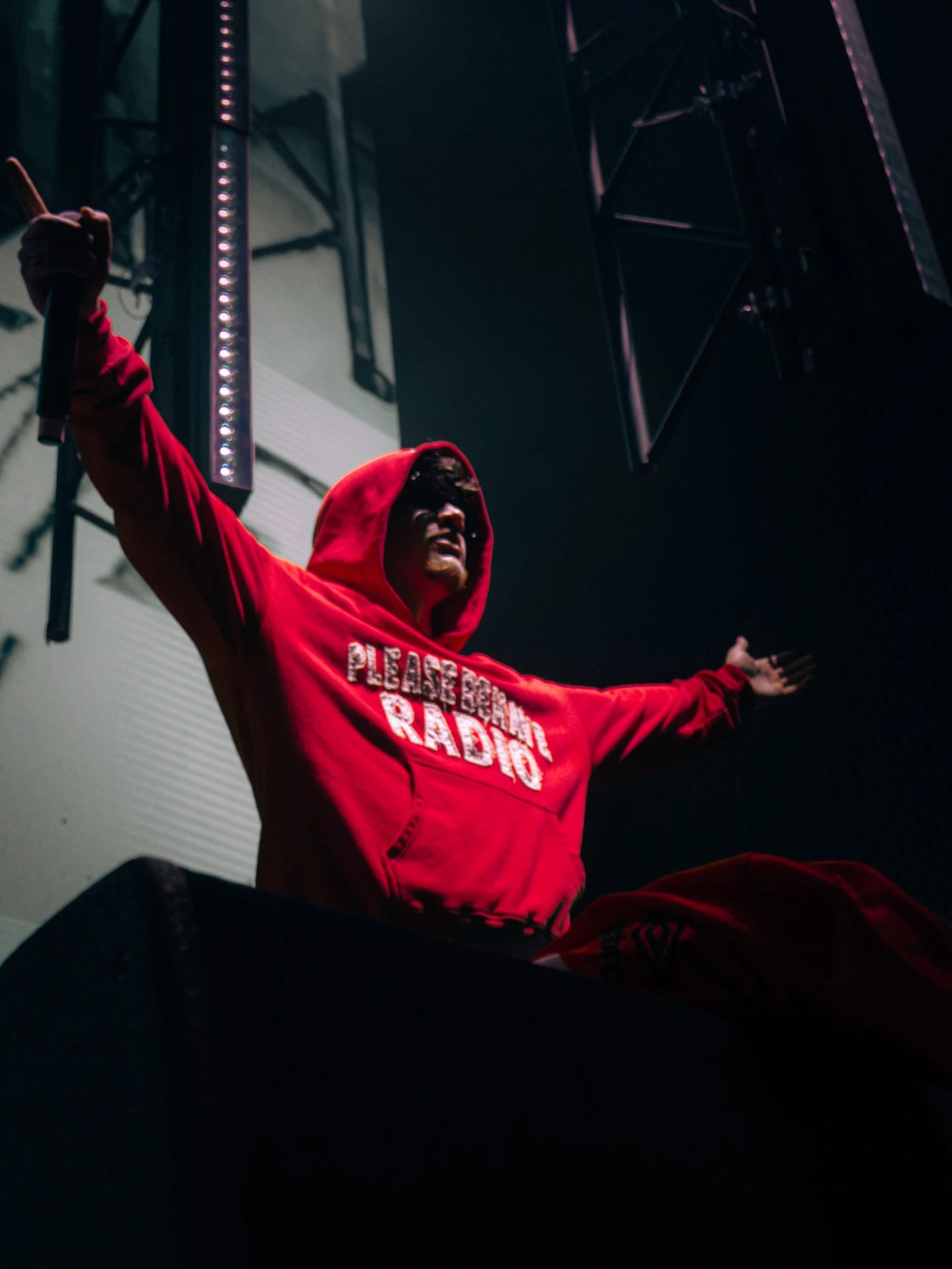 Artista en concierto con sudadera roja